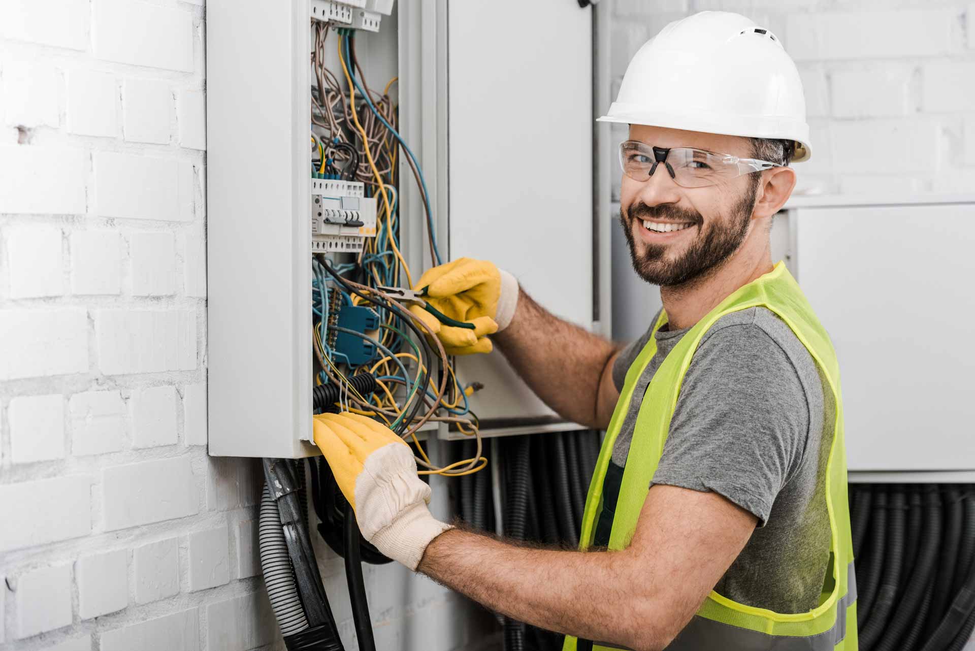 Happy Electrician Working on a Fuseboard