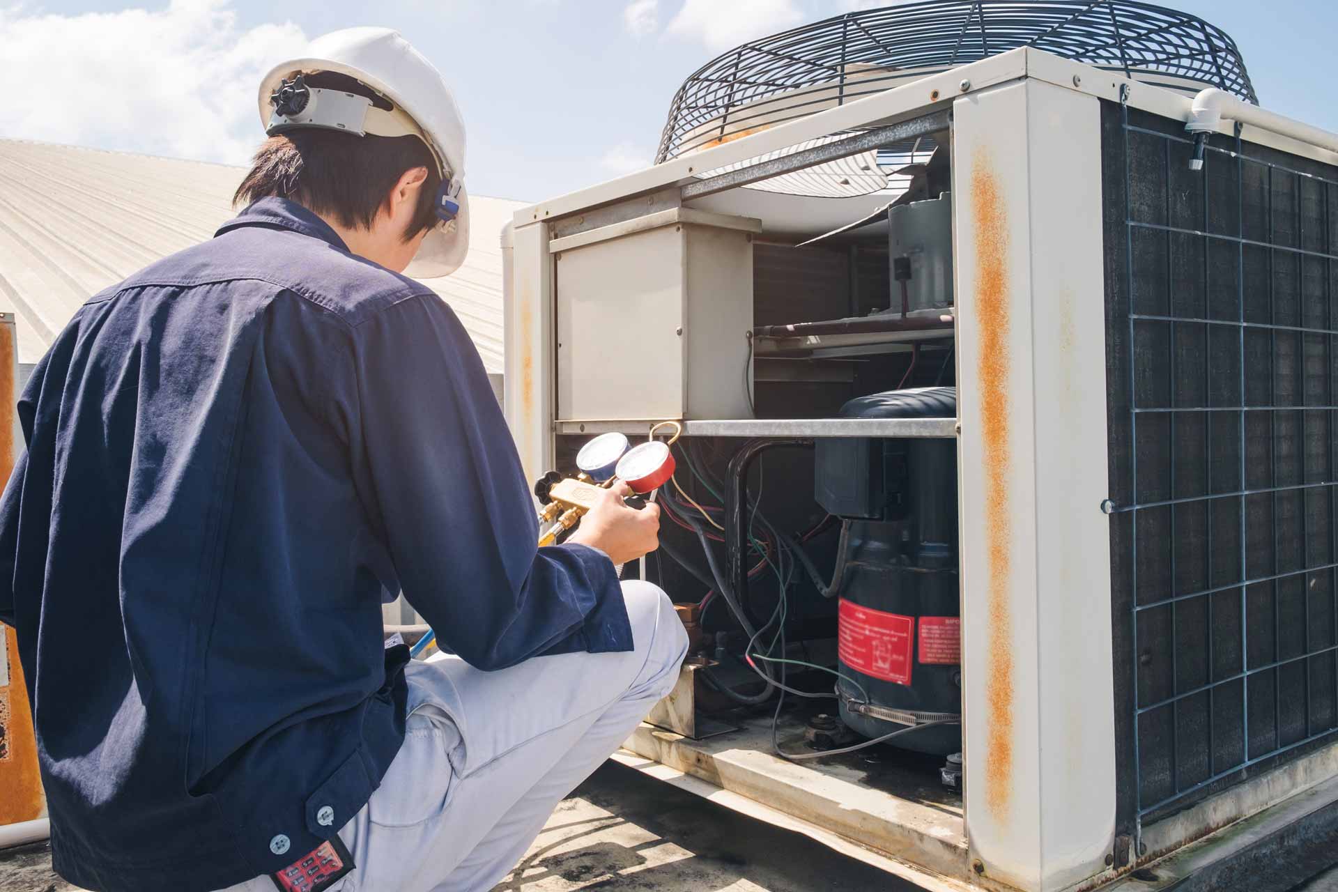 Electrician working on a large outdoor generator